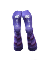Photo showing the soles of a pair of purple socks with the word RANZCOG on the bottom
